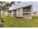 Exterior view of condo building with lawn at 12321 Sun Vista W Ct # 52, Treasure Island, FL 33706