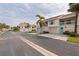 Exterior view of the townhome featuring a two-story facade, private balconies, and well-kept landscaping at 12321 Sun Vista W Ct # 52, Treasure Island, FL 33706
