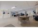 Spacious garage with an epoxy floor, string lights, and ample space for a dining table at 12321 Sun Vista W Ct # 52, Treasure Island, FL 33706