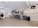 Spacious garage with an epoxy floor, string lights, a work bench, and ample space for a storage at 12321 Sun Vista W Ct # 52, Treasure Island, FL 33706