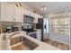 Open-concept kitchen, dining, and living area with quartz counters, stainless appliances, and neutral décor at 12321 Sun Vista W Ct # 52, Treasure Island, FL 33706