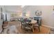 Bright dining area with a round table and chairs adjacent to a spacious living room at 12321 Sun Vista W Ct # 52, Treasure Island, FL 33706