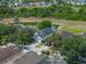 Aerial view of a residential community with well-maintained homes, lush greenery, and a community pond at 12713 Whitney Meadow Way, Riverview, FL 33578