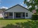 Home's backyard features screened-in lanai and well-maintained lawn at 12713 Whitney Meadow Way, Riverview, FL 33578