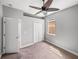 Bedroom features an open door, neutral carpeting and large window at 12713 Whitney Meadow Way, Riverview, FL 33578