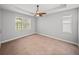 Spacious bedroom with a ceiling fan, neutral walls, and carpet flooring at 12713 Whitney Meadow Way, Riverview, FL 33578