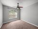 Bedroom featuring neutral paint, carpet, a ceiling fan, and a window at 12713 Whitney Meadow Way, Riverview, FL 33578