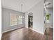 Dining room featuring wood floors, neutral paint, and a view of the kitchen at 12713 Whitney Meadow Way, Riverview, FL 33578
