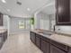 Eat-in kitchen featuring modern cabinets, stainless sink, tile flooring, and lots of natural light at 12713 Whitney Meadow Way, Riverview, FL 33578