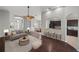 Bright, open-concept living room with stylish furnishings and seamless flow to kitchen and dining areas at 12713 Whitney Meadow Way, Riverview, FL 33578