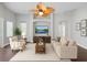 Inviting living room with archways, neutral walls, a ceiling fan, and modern decor at 12713 Whitney Meadow Way, Riverview, FL 33578