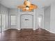 Spacious living room with wood floors, neutral paint, elegant archways, and a ceiling fan at 12713 Whitney Meadow Way, Riverview, FL 33578