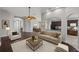 Open-concept living room featuring wood floors, neutral paint, elegant archways, and views of the dining room and kitchen at 12713 Whitney Meadow Way, Riverview, FL 33578