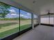 Covered patio with screened enclosure offering tranquil views of the backyard and beyond at 12713 Whitney Meadow Way, Riverview, FL 33578