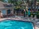 Relaxing community pool, playground, and seating area at 12713 Whitney Meadow Way, Riverview, FL 33578