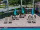 Inviting pool deck with comfortable lounge chairs and umbrellas at 12713 Whitney Meadow Way, Riverview, FL 33578
