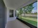 Relaxing screened-in porch with a view of lush greenery at 12713 Whitney Meadow Way, Riverview, FL 33578