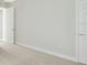 Bedroom featuring neutral carpet, base trim, and natural light at 13137 Wellspring Dr, Lithia, FL 33547