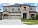 Beautiful two-story home featuring a three-car garage and stone accents at 13137 Wellspring Dr, Lithia, FL 33547