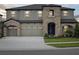 Beautiful two-story home with stone accents and a spacious three-car garage at 13137 Wellspring Dr, Lithia, FL 33547