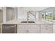 Open concept kitchen with stainless steel dishwasher and a large island with sink and faucet at 13137 Wellspring Dr, Lithia, FL 33547