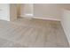 Neutral carpeted room featuring white trim and baseboards leading to other rooms in the house at 13137 Wellspring Dr, Lithia, FL 33547