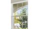 A clear window showing the trees outside at 13137 Wellspring Dr, Lithia, FL 33547