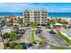Aerial shot of condo building, landscaped grounds, parking lot, and the ocean at 13440 Gulf Blvd # 501, Madeira Beach, FL 33708