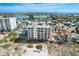Stunning aerial view of beachfront condos with balconies, pool, and ocean views on a sunny day at 13440 Gulf Blvd # 501, Madeira Beach, FL 33708
