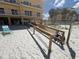 Handicap accessible beach access with wooden ramp and lounge chair on the sand at 13440 Gulf Blvd # 501, Madeira Beach, FL 33708