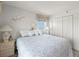 Bright bedroom with a large bed, soft lighting, and a beautiful ocean view from the window at 13440 Gulf Blvd # 501, Madeira Beach, FL 33708
