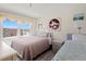 Comfortable bedroom with two beds and a large window offering a nice view of the ocean at 13440 Gulf Blvd # 501, Madeira Beach, FL 33708