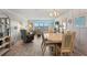 Dining area featuring a large table with seating for six, wood-look floors and views of the water at 13440 Gulf Blvd # 501, Madeira Beach, FL 33708