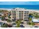Beachfront condo building with balconies overlooking the ocean, parking and neighboring property at 13440 Gulf Blvd # 501, Madeira Beach, FL 33708