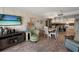 Living and dining area with wood-look flooring, furniture and TV at 13440 Gulf Blvd # 501, Madeira Beach, FL 33708
