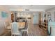 Spacious living room and dining area with views to the kitchen and featuring wood flooring at 13440 Gulf Blvd # 501, Madeira Beach, FL 33708