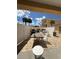 Outdoor grilling area with dining tables and chairs, perfect for entertaining guests at 13440 Gulf Blvd # 501, Madeira Beach, FL 33708