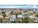 Aerial view of a waterfront community with multiple homes and docks along canal under blue skies at 13918 Raie Ave, Hudson, FL 34667