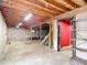 Basement area featuring concrete walls, exposed beams, and a set of stairs at 13918 Raie Ave, Hudson, FL 34667