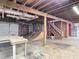 Unfinished basement with exposed wood beams, concrete floor, and potential for customization at 13918 Raie Ave, Hudson, FL 34667
