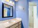 Standard bathroom featuring a shower, vanity with sink, and a framed mirror at 13918 Raie Ave, Hudson, FL 34667