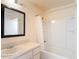 Bathroom features a vanity, mirror, and a bathtub with a shower at 13918 Raie Ave, Hudson, FL 34667