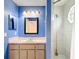 Standard bathroom showcasing a shower, vanity with sink, and a framed mirror with overhead lighting at 13918 Raie Ave, Hudson, FL 34667
