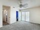 Cozy bedroom with a ceiling fan, closet, and a sliding glass door to the patio at 13918 Raie Ave, Hudson, FL 34667