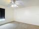 Spare bedroom has a ceiling fan and a window with a curtain for privacy at 13918 Raie Ave, Hudson, FL 34667