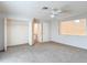 Bright bedroom featuring neutral carpet, a ceiling fan, and double-door closets at 13918 Raie Ave, Hudson, FL 34667