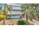 Waterfront home boasts dual balconies, tropical landscaping, and a large garage with outdoor access at 13918 Raie Ave, Hudson, FL 34667