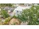 Waterfront home with a paved driveway offers dual balconies with tropical landscaping in the front yard at 13918 Raie Ave, Hudson, FL 34667