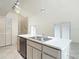Bright kitchen island with stainless sink offers space for food prep, socializing and dining at 13918 Raie Ave, Hudson, FL 34667