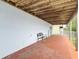 Covered patio with stained concrete, wooden ceilings, and patio chair with view of fenced yard at 13918 Raie Ave, Hudson, FL 34667